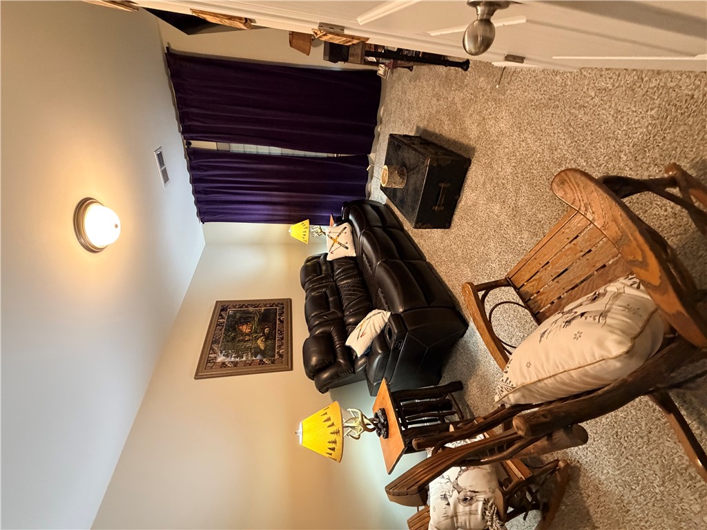 203 Legacy Lane Liberty, SC 29657 - Photo 36 of 47 This inviting living area features soft carpeting and warm lighting for ultimate comfort.