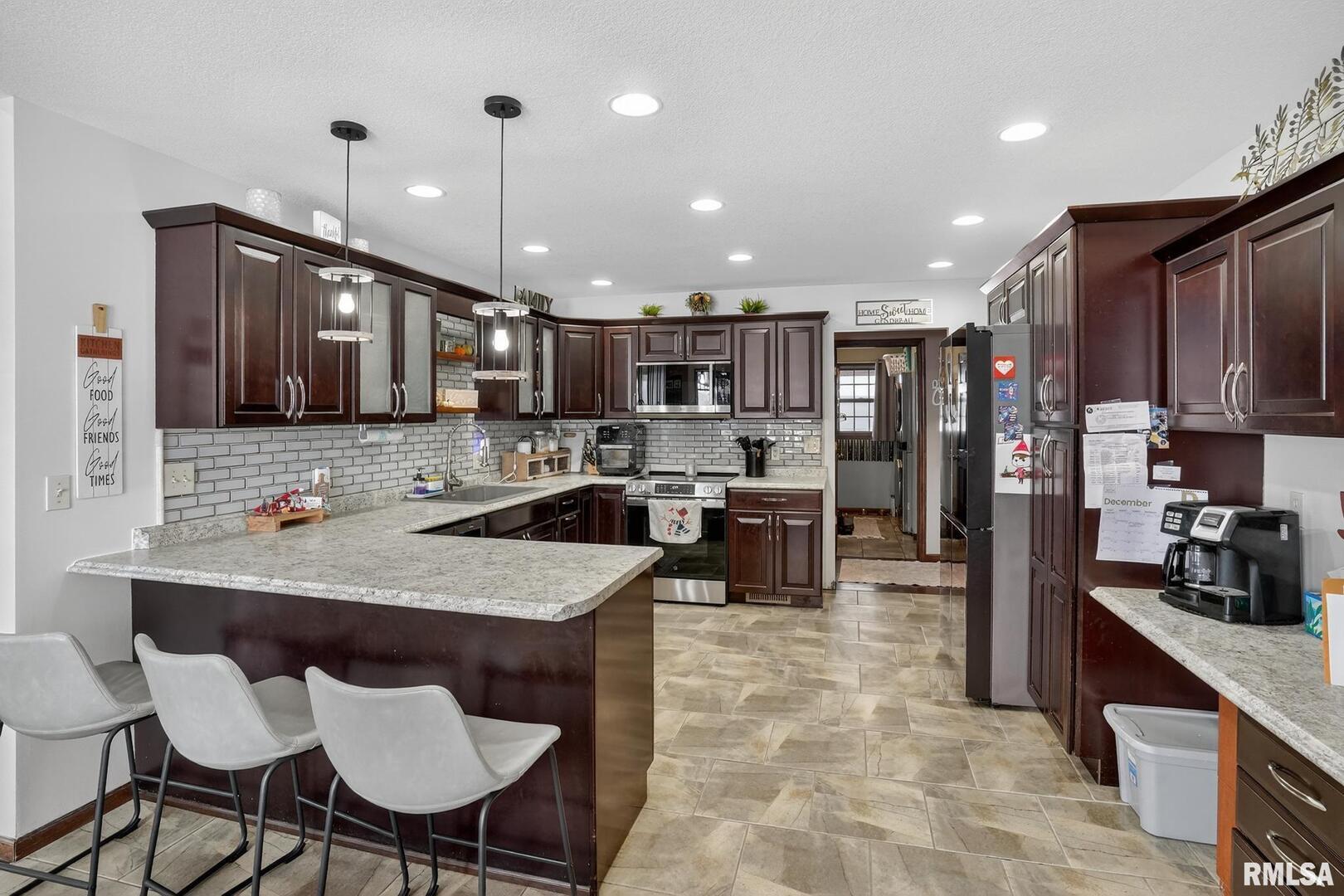 5759 Riverview Road Thomson, IL 61285 - Photo 19 of 49 a kitchen with stainless steel appliances granite countertop a sink refrigerator and cabinets