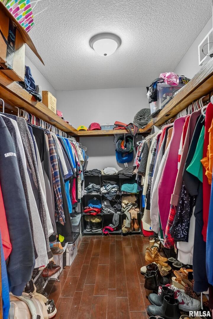 5759 Riverview Road Thomson, IL 61285 - Photo 31 of 49 a view of walk in closet with clothes
