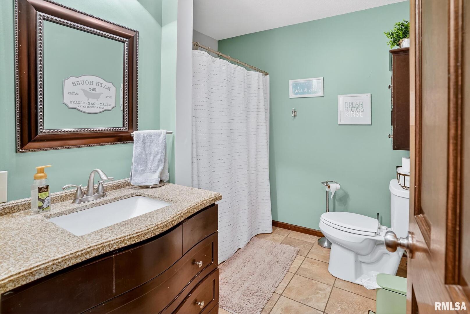 5759 Riverview Road Thomson, IL 61285 - Photo 36 of 49 a bathroom with a granite countertop sink mirror and toilet