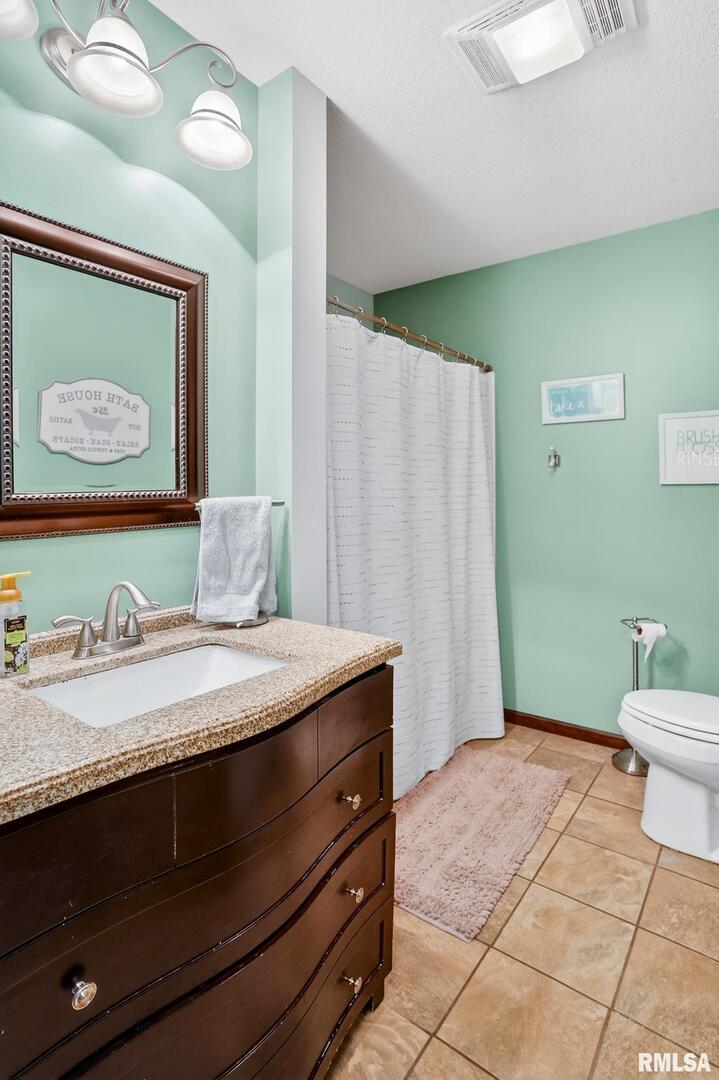 5759 Riverview Road Thomson, IL 61285 - Photo 37 of 49 a bathroom with a granite countertop sink toilet and mirror