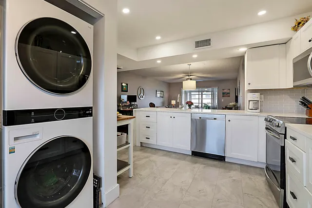 a view of a kitchen with a washer and dryer