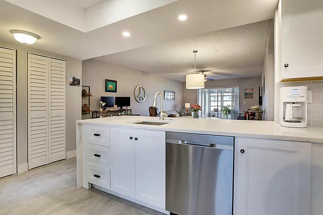 a kitchen with cabinets and window