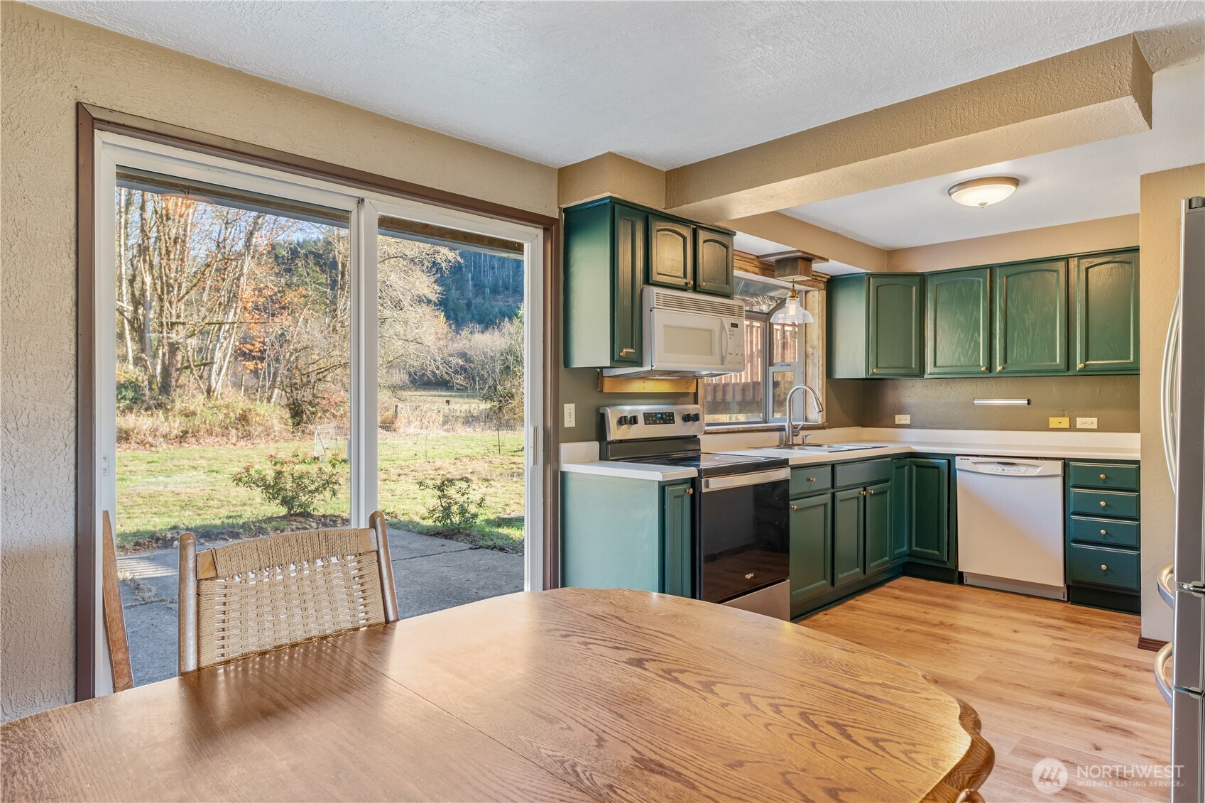 124 Highland Valley Road Morton, WA 98356 - Photo 12 of 36 a kitchen with stainless steel appliances granite countertop a refrigerator and sink