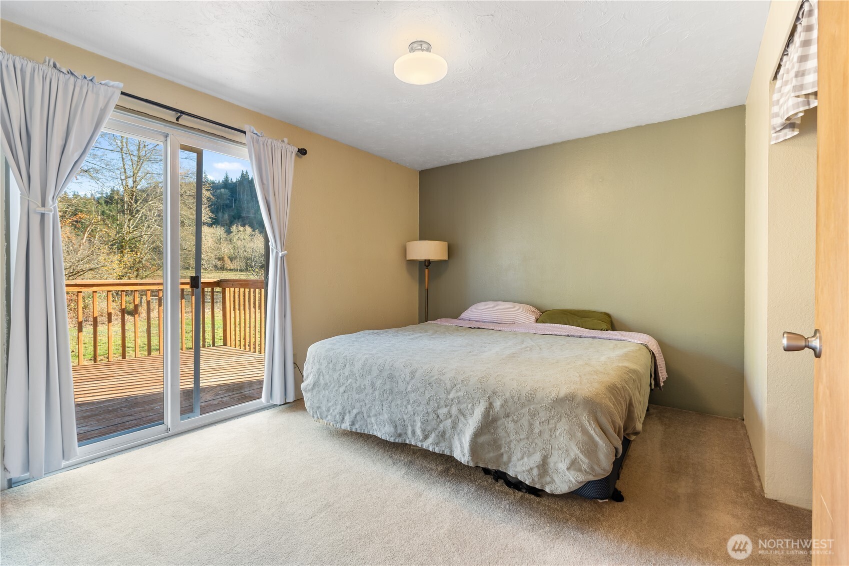 124 Highland Valley Road Morton, WA 98356 - Photo 13 of 36 a spacious bedroom with a bed and a window
