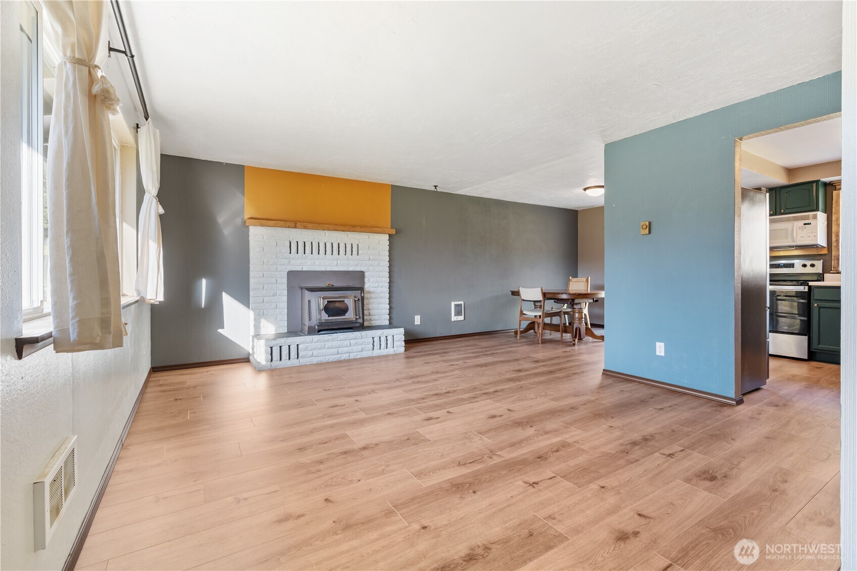 124 Highland Valley Road Morton, WA 98356 - Photo 4 of 36 a view of an empty room with a fireplace and a window