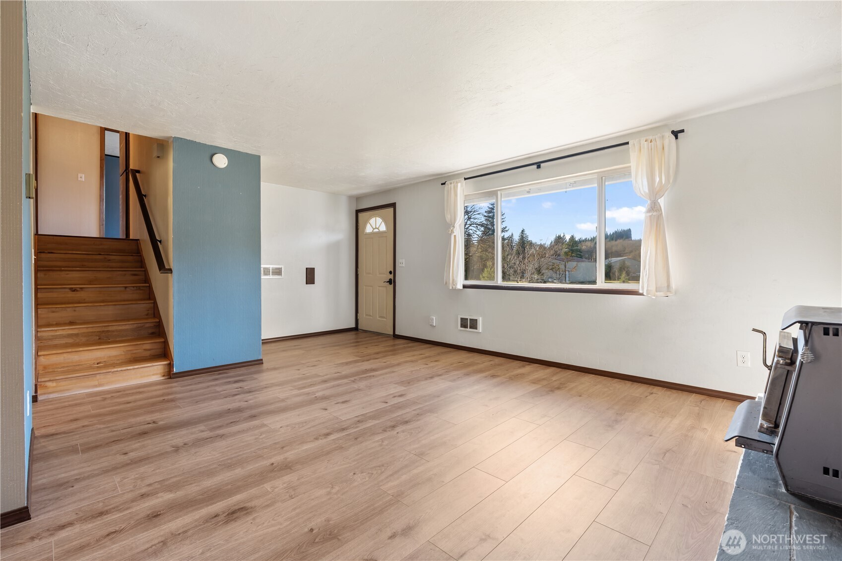 124 Highland Valley Road Morton, WA 98356 - Photo 5 of 36 a view of a big room with wooden floor and windows