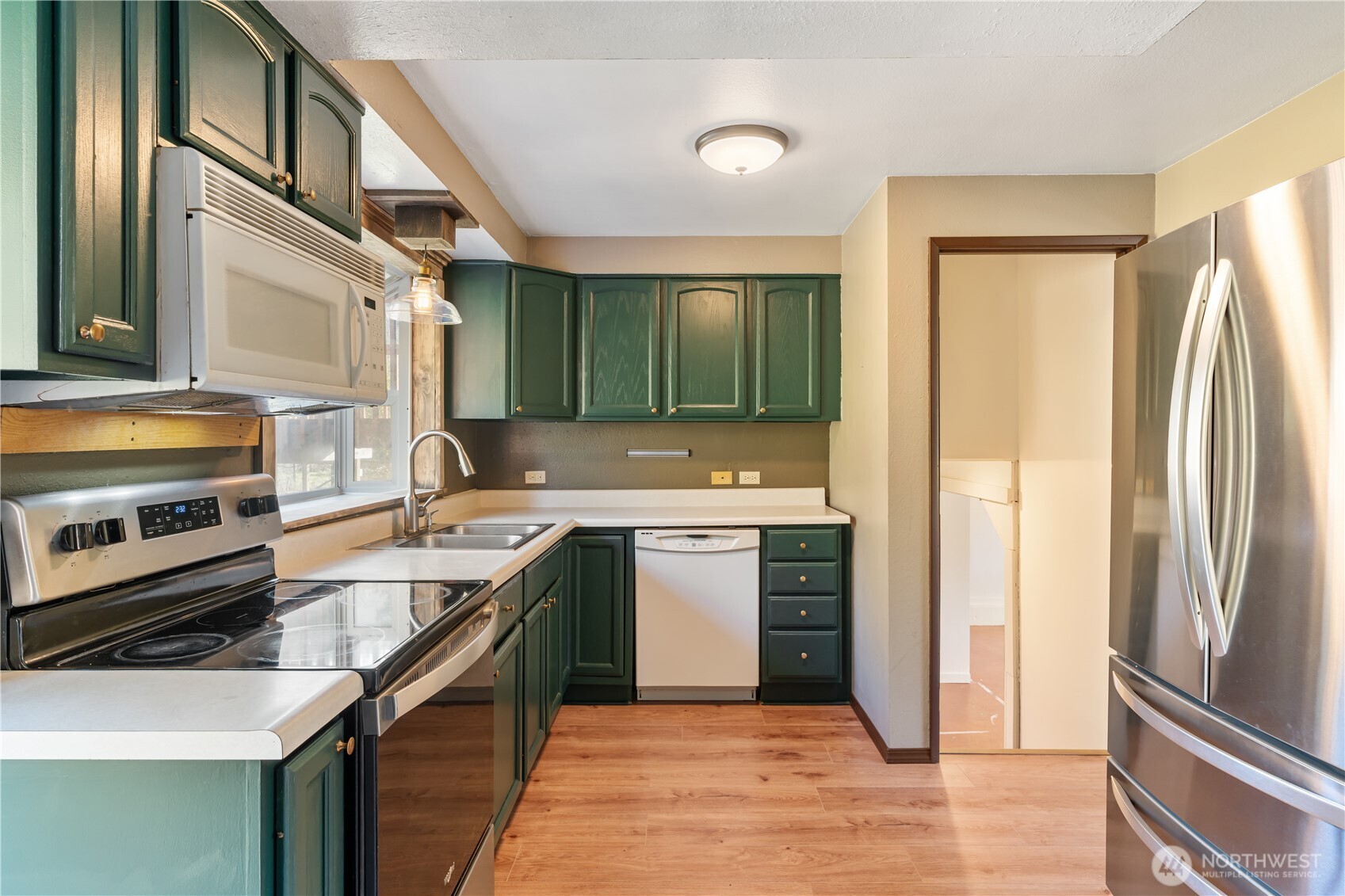 124 Highland Valley Road Morton, WA 98356 - Photo 7 of 36 a kitchen with a sink stove and refrigerator