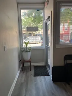 a workspace with wooden floor and a window
