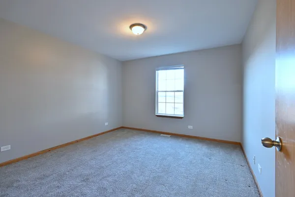 an empty room with a empty space and windows