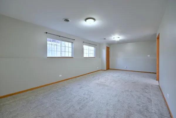 a view of an empty room with windows