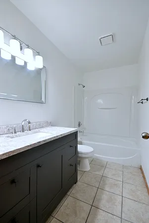 a bathroom with a sink a toilet and bathtub