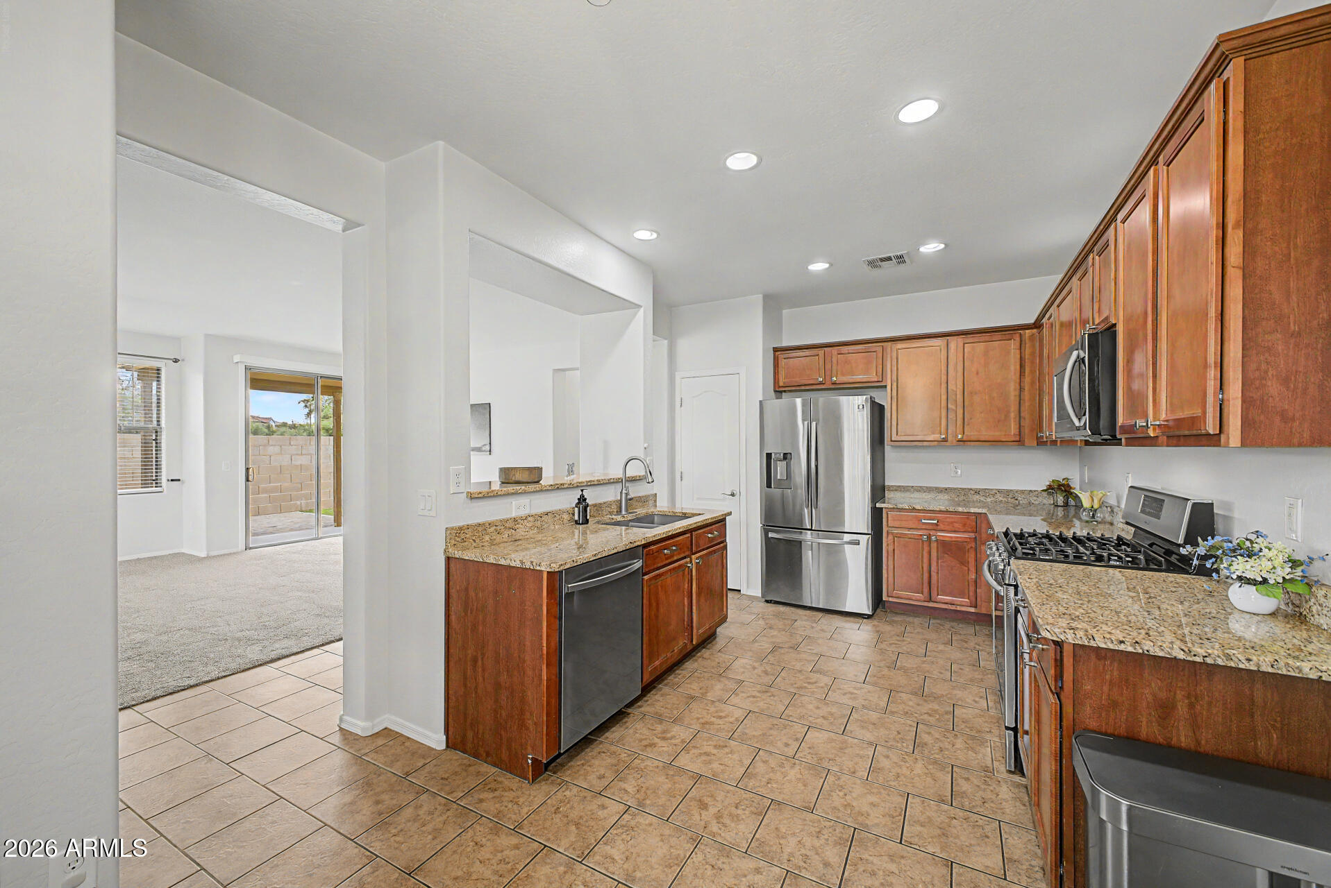 2868 South Anderson Lane Gilbert, AZ 85295 - Photo 12 of 59 a kitchen with stainless steel appliances granite countertop a stove a sink and a refrigerator