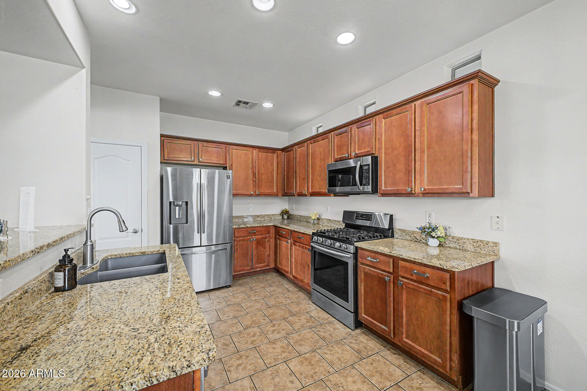 2868 South Anderson Lane Gilbert, AZ 85295 - Photo 14 of 59 a kitchen with a refrigerator stove top oven and sink