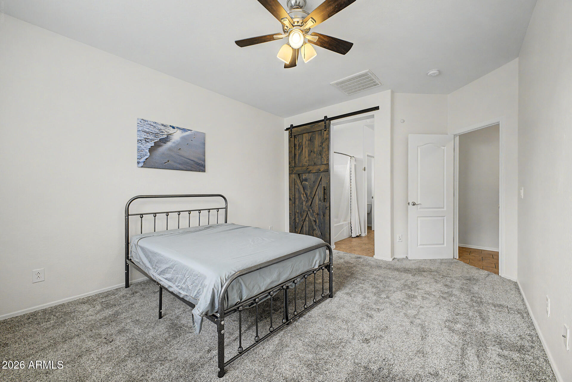2868 South Anderson Lane Gilbert, AZ 85295 - Photo 19 of 59 a bedroom with a bed and a chandelier