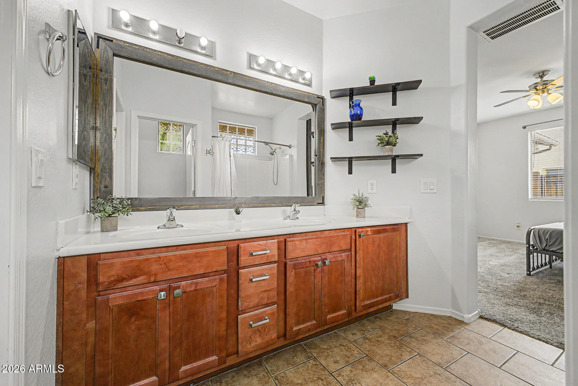 2868 South Anderson Lane Gilbert, AZ 85295 - Photo 21 of 59 a spacious bathroom with a double vanity sink and a mirror