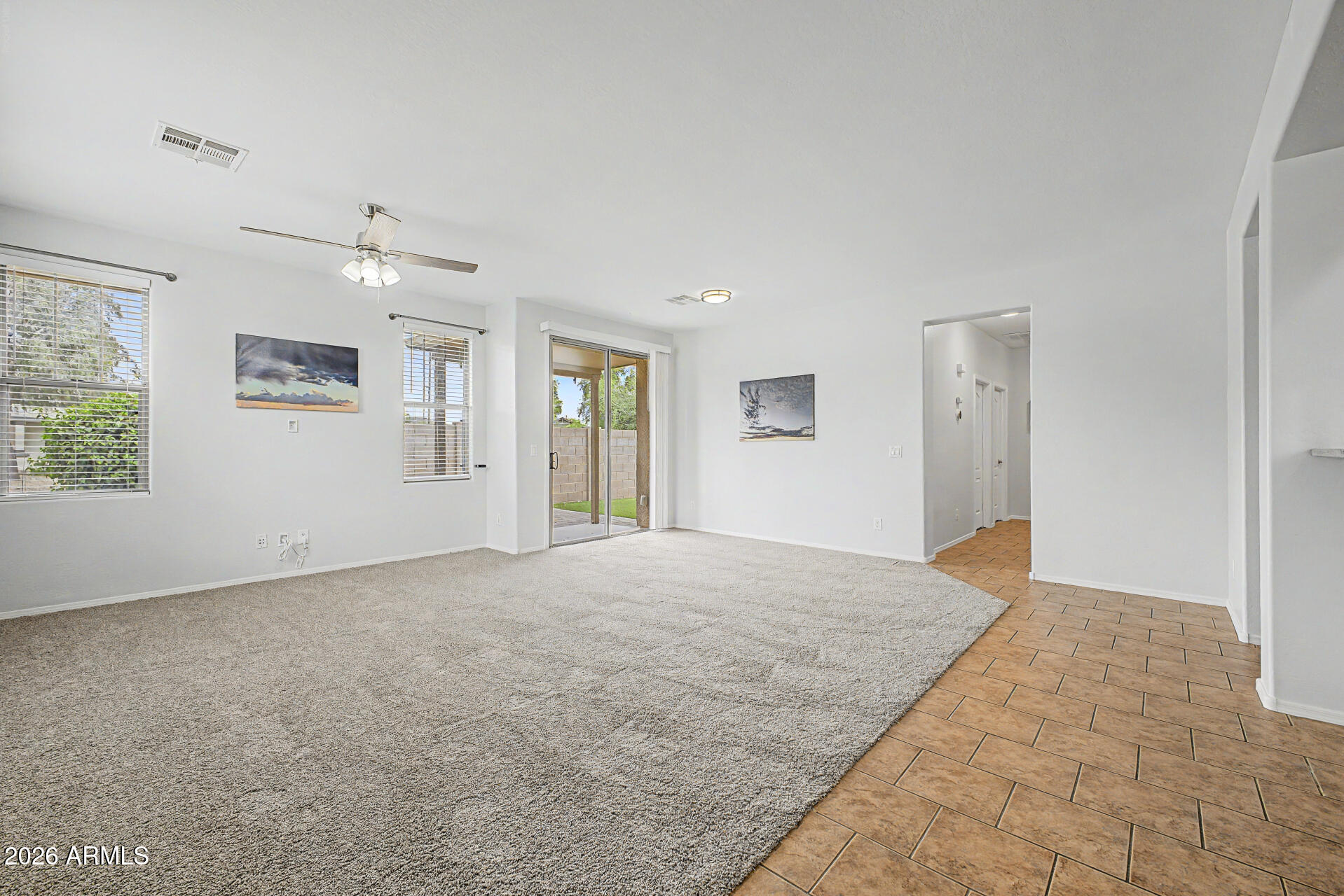 2868 South Anderson Lane Gilbert, AZ 85295 - Photo 6 of 59 an empty room with windows and ceiling fan