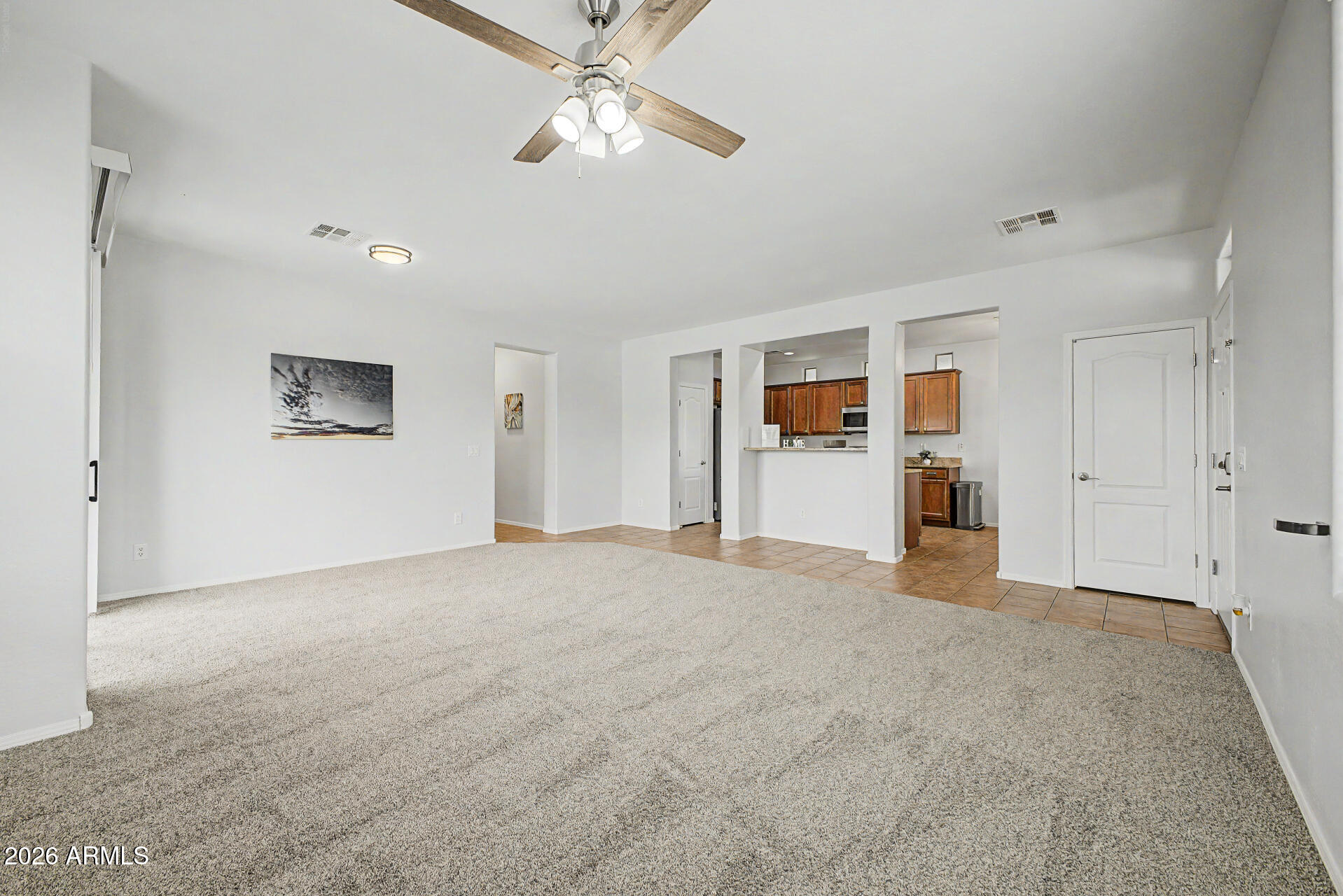2868 South Anderson Lane Gilbert, AZ 85295 - Photo 9 of 59 a view of a livingroom with a chandelier fan and windows