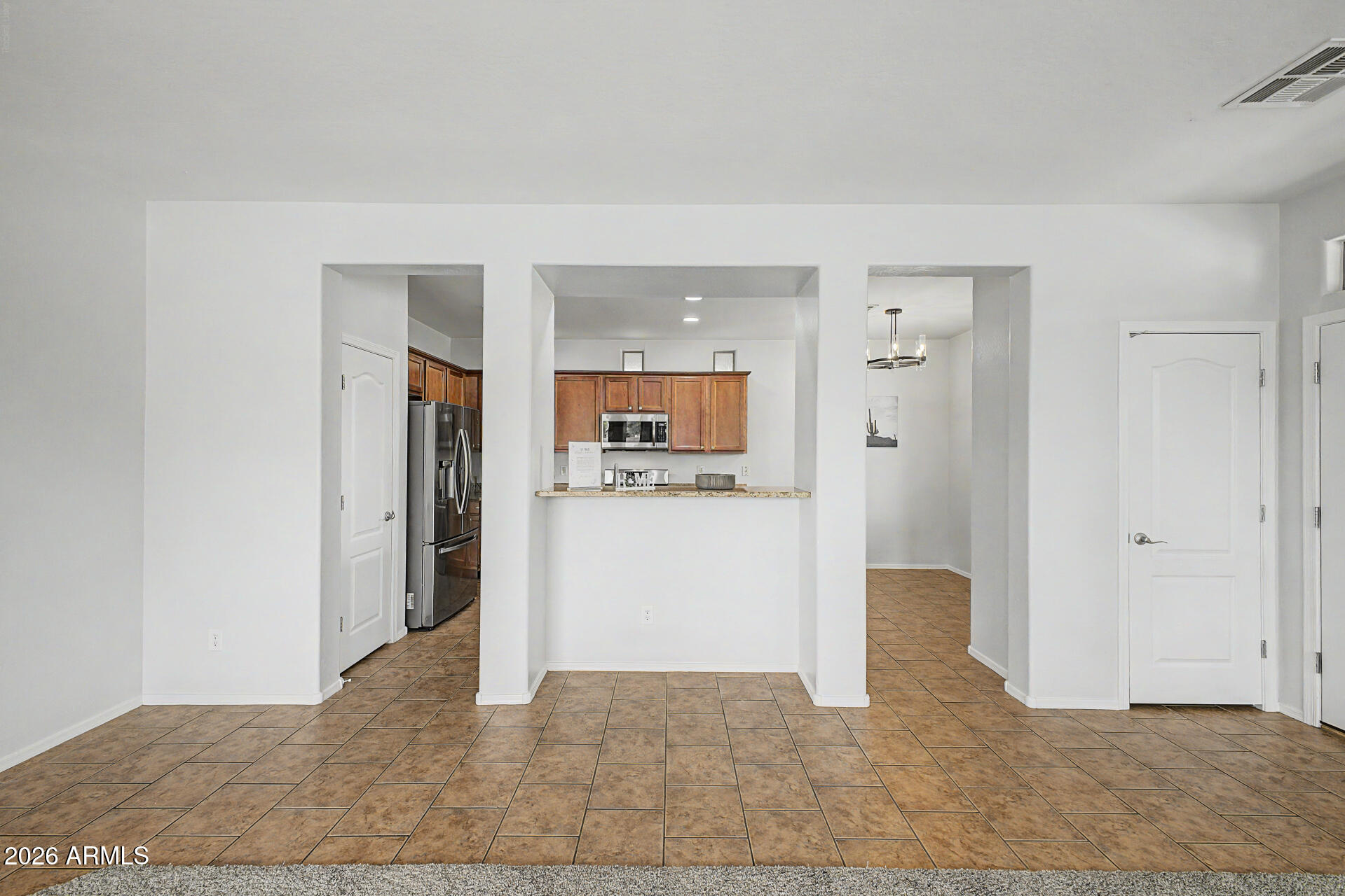 2868 South Anderson Lane Gilbert, AZ 85295 - Photo 10 of 59 a view of a hallway with wooden floor and a living room