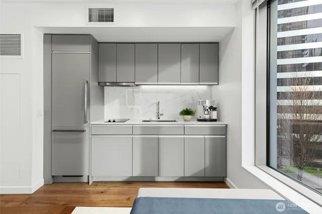 a kitchen with stainless steel appliances granite countertop a sink and cabinets
