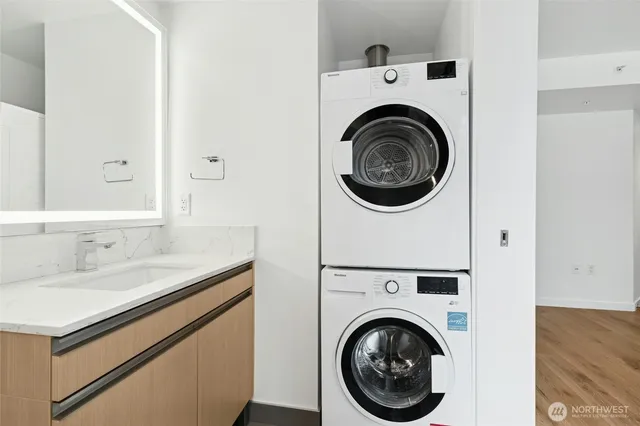 a utility room with sink dryer and washer