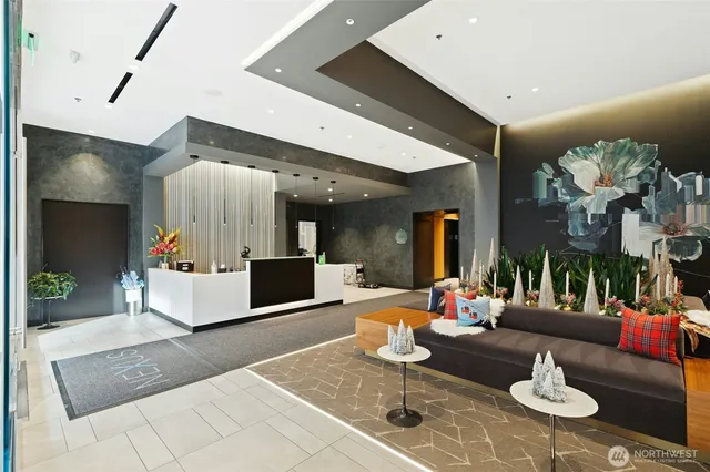 a living room with furniture and kitchen view