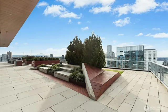 a view of swimming pool with seating space and barbeque oven in the back