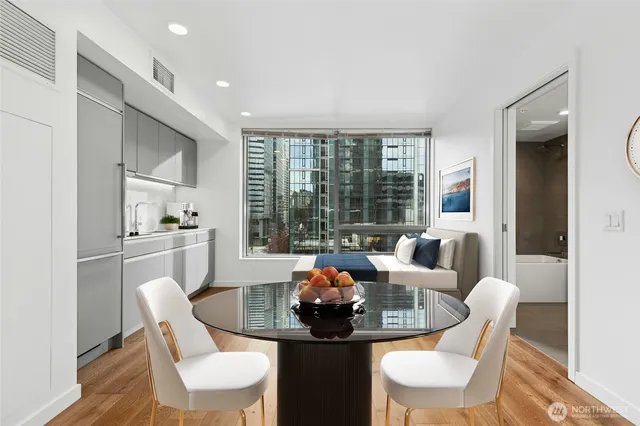 a dining room with furniture and a large window