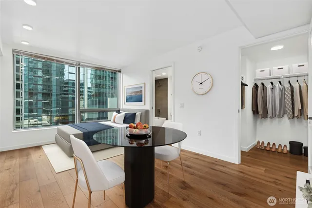 a dining room with furniture and wooden floor