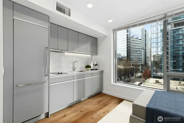 a kitchen with stainless steel appliances a sink and cabinets