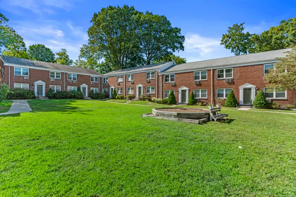 a house view with swimming pool and garden