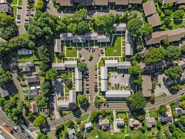 an aerial view of multi story residential apartment building with outdoor space
