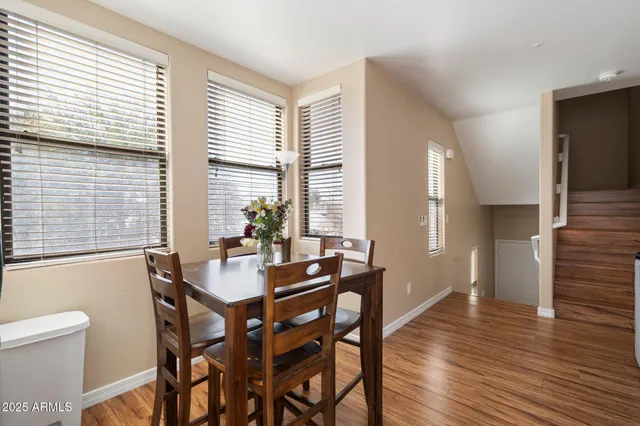 a dining room with furniture and wooden floor