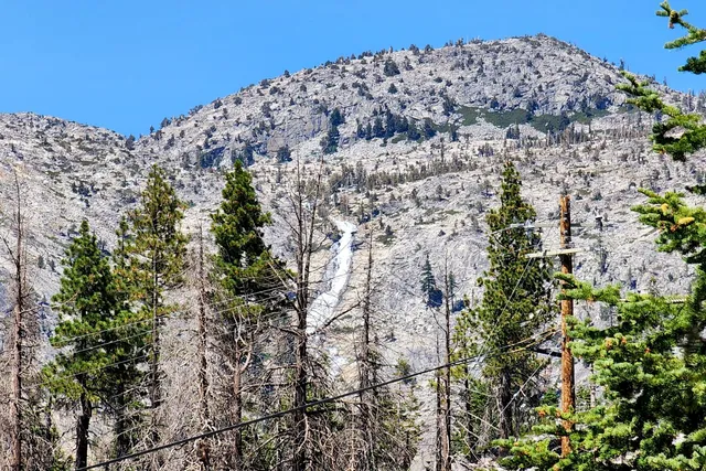 a large building with a mountain in the background