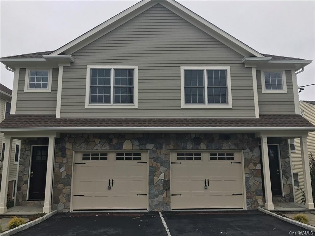 View of front of house and 1 car garage