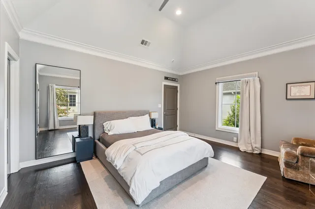 a bathroom with a granite countertop sink vanity mirror and toilet