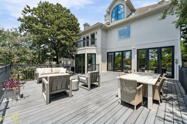 an aerial view of a city with lots of residential buildings ocean and mountain view in back