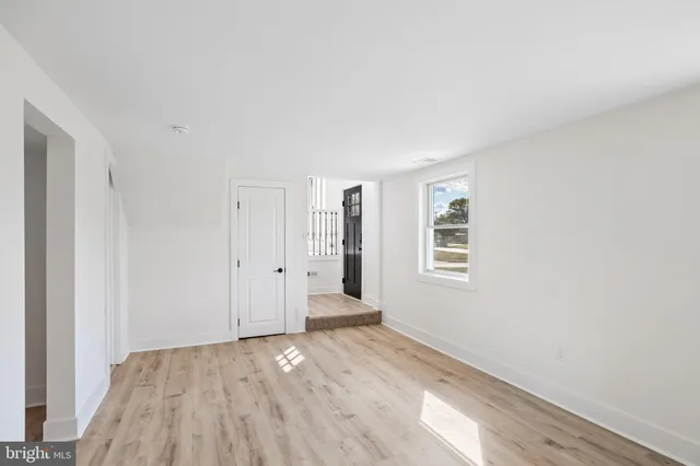 a view of a room with wooden floor and window