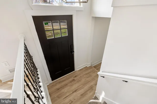 a view of an entryway with wooden floor