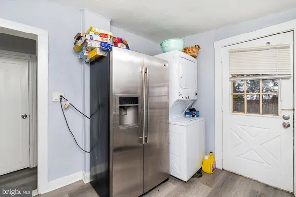 a kitchen with stainless steel appliances a refrigerator and a ceiling fan