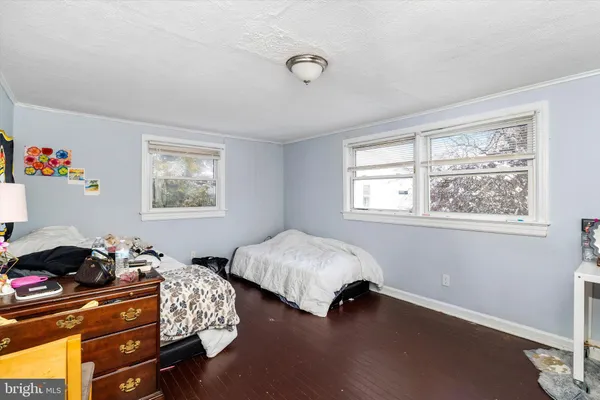a bedroom with two beds and a window