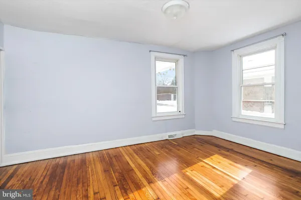 a view of a room with wooden floor and window