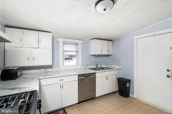 a kitchen with a sink cabinets and appliances