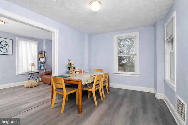 a dining room with furniture and wooden floor