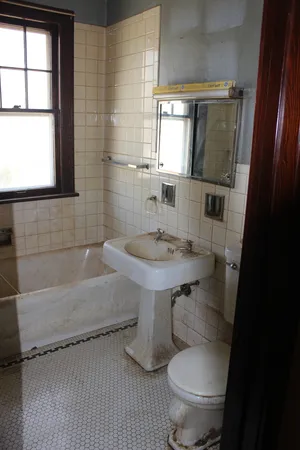 a bathroom with a sink toilet and mirror