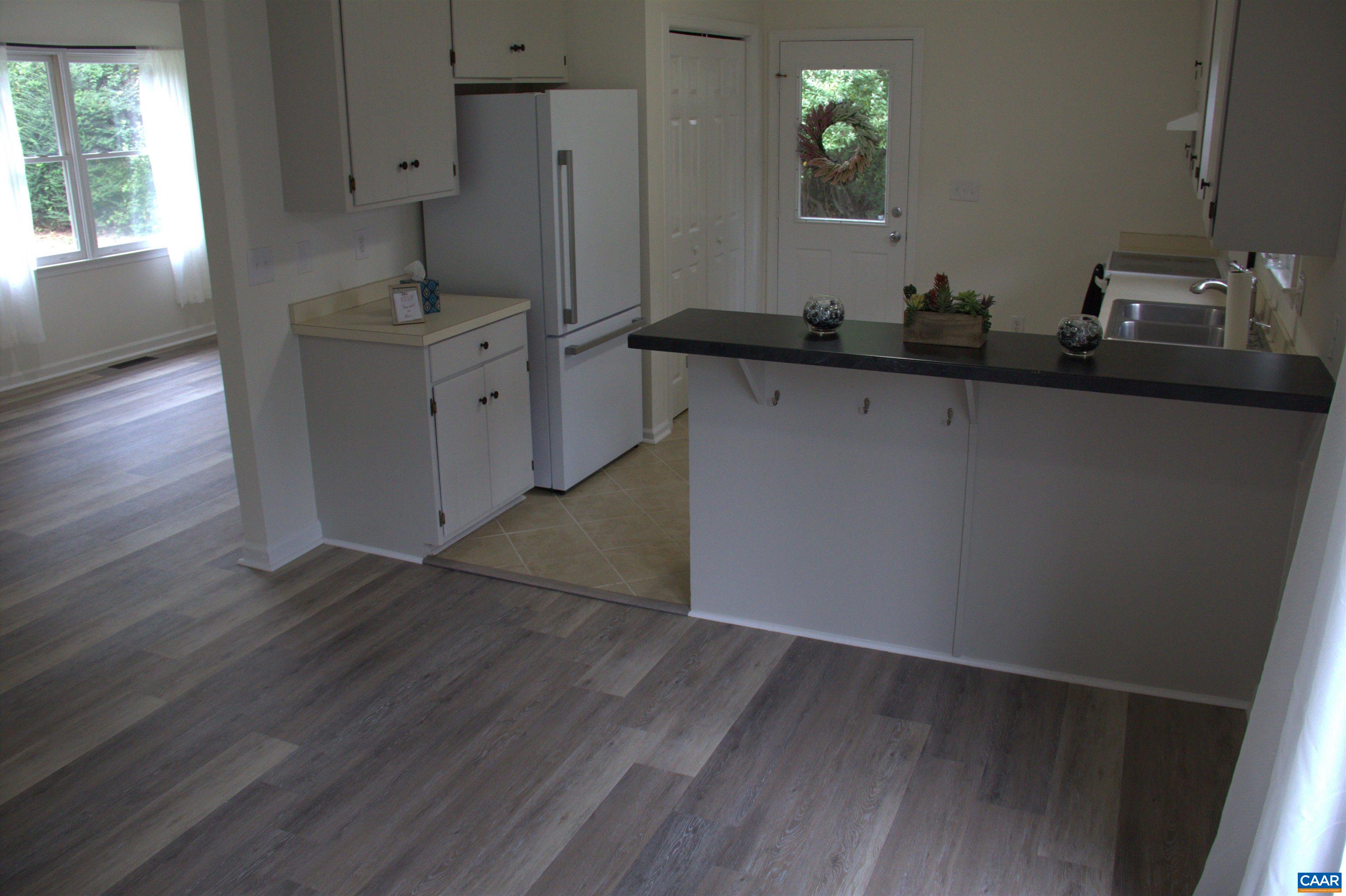 122 Petunia Road Ruckersville, VA 22968 - Photo 20 of 59 a kitchen with sink cabinets and wooden floor