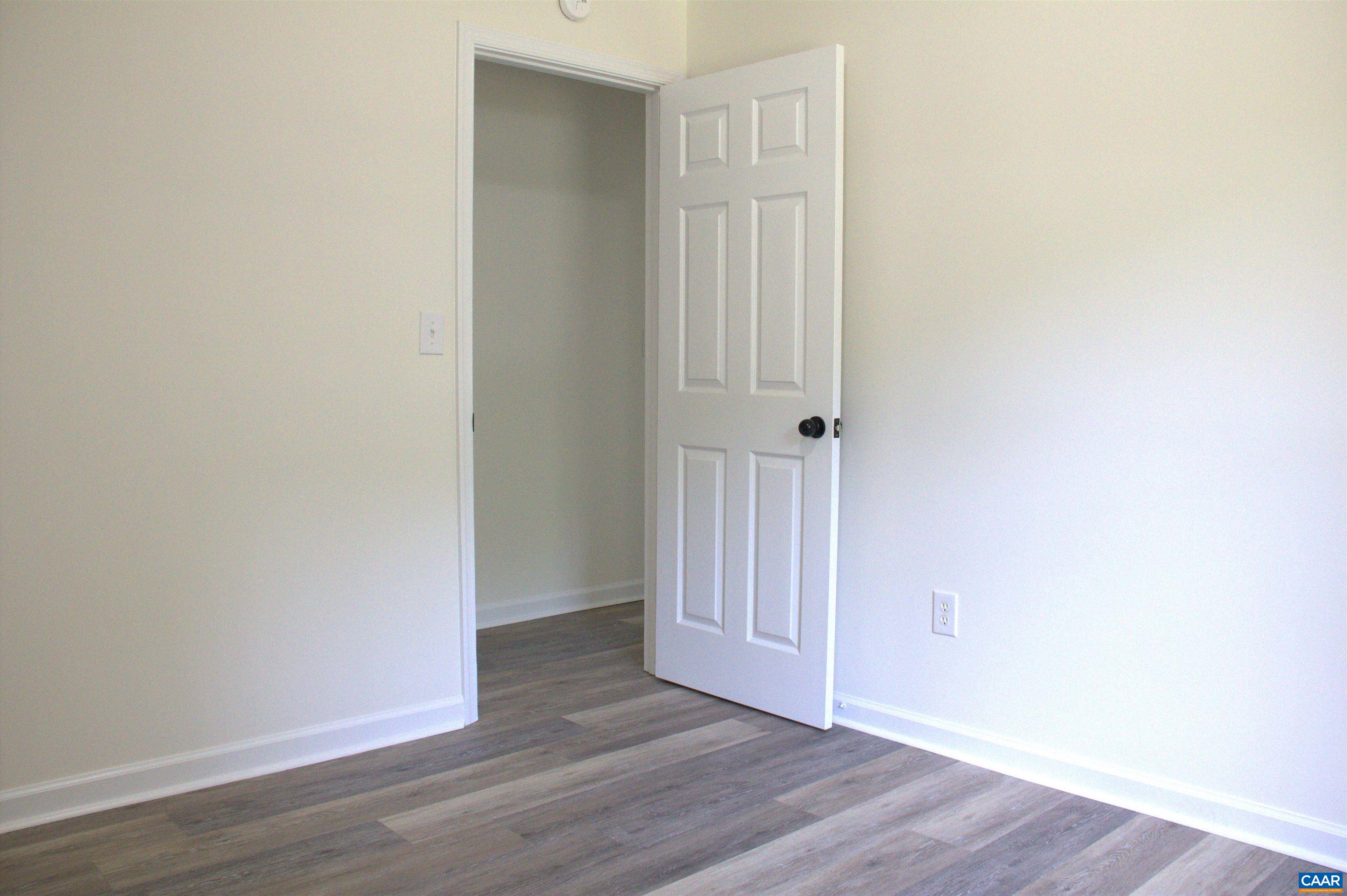 122 Petunia Road Ruckersville, VA 22968 - Photo 21 of 59 a view of an empty room with wooden floor