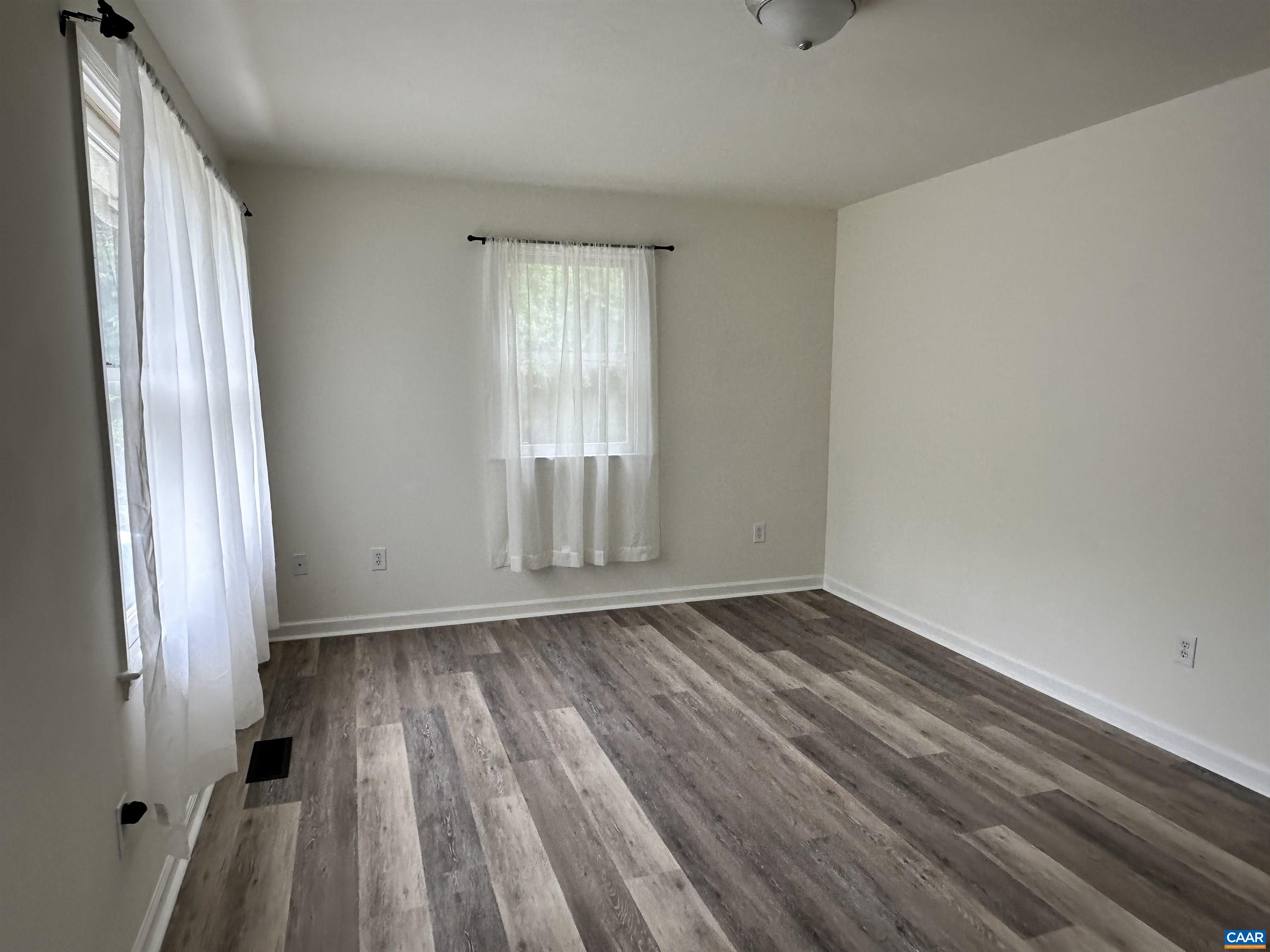122 Petunia Road Ruckersville, VA 22968 - Photo 22 of 59 a view of an empty room with wooden floor and a window