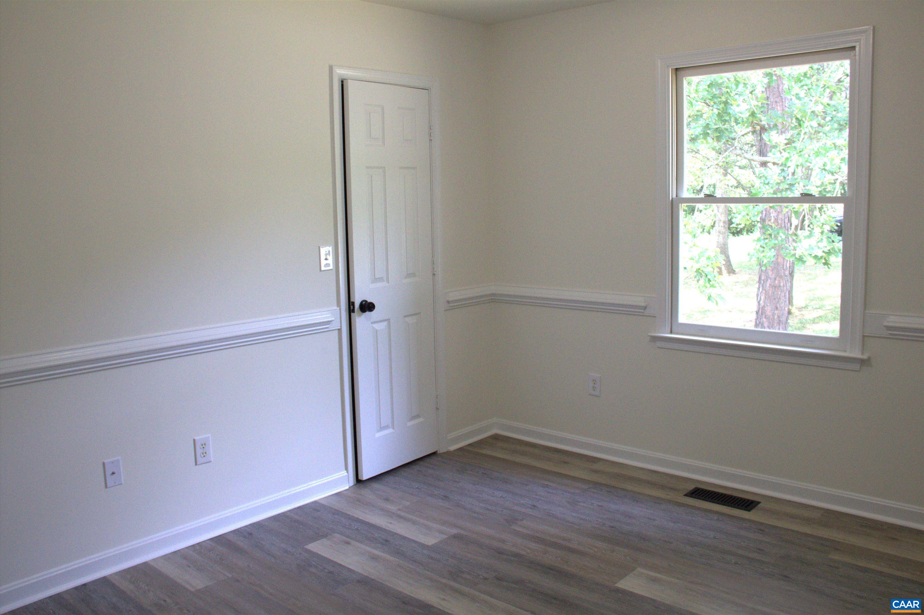 122 Petunia Road Ruckersville, VA 22968 - Photo 30 of 59 an empty room with wooden floor and windows