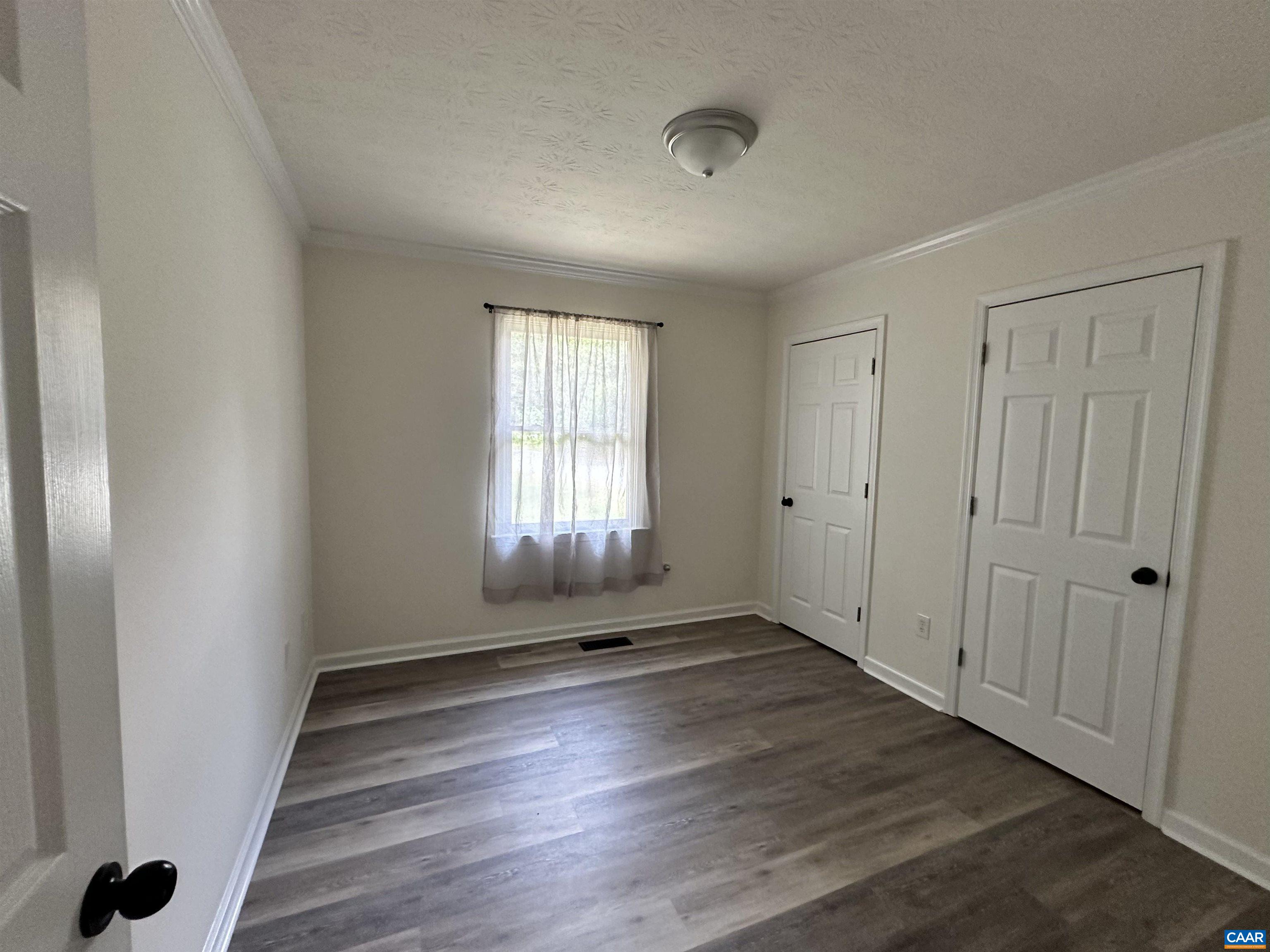 122 Petunia Road Ruckersville, VA 22968 - Photo 32 of 59 an empty room with wooden floor and windows